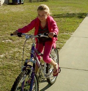 moo, age 7, on sissy's cool purple bike