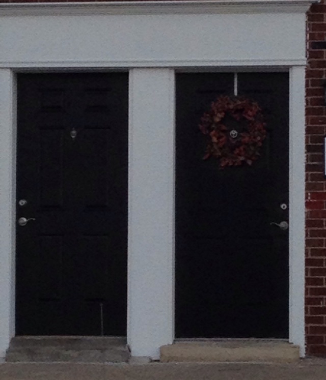on nearby townhomes -- i like the way the wreath repeats the color of the brick